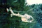 Вертолет Bo.105 на фоне деревьев